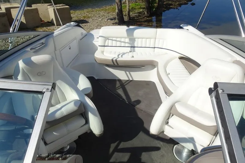 Slide: The Image of Interior of a 2003 Cobalt 24SD boat with white seating and open layout. - 20