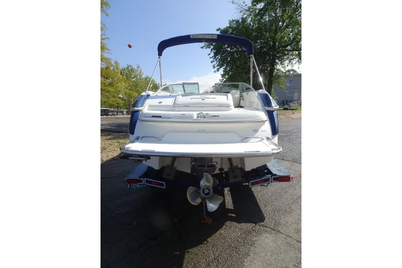 Slide: The Image of Rear view of a 2003 Cobalt 24SD boat on a trailer, parked outdoors. - 6