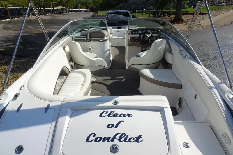 Slide: The Image of 2003 Cobalt 24SD boat interior with white seating and "Clear of Conflict" text. - 8