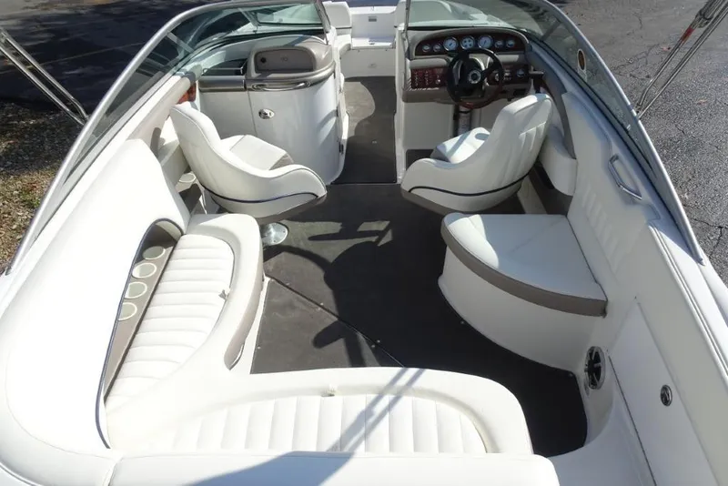 Slide: The Image of 2003 Cobalt 24SD boat interior with white seating and modern dashboard design. - 9