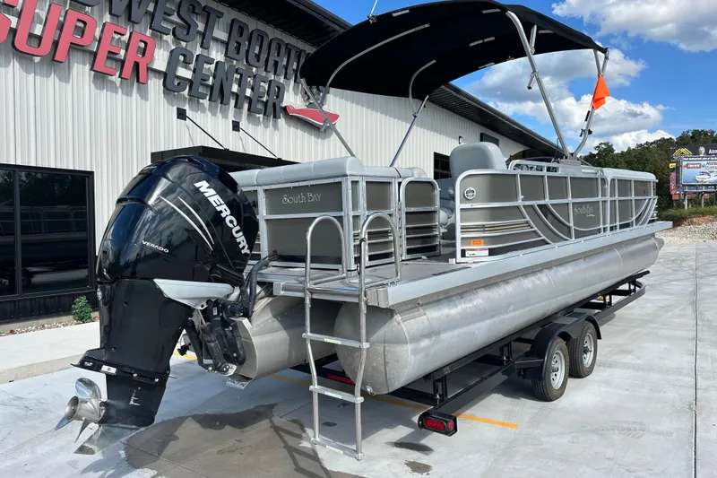 Slide: The Image of 2011 South Bay 925 CR pontoon boat with Mercury engine at dealership. - 1