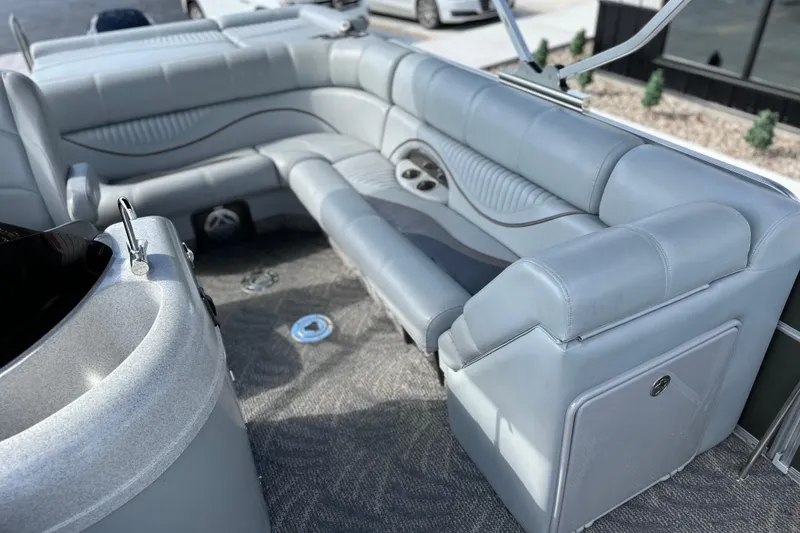 Slide: The Image of 2011 South Bay 925 CR boat interior with gray seating and cup holders. - 16