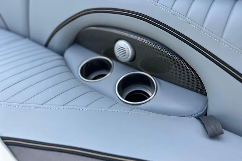 Slide: The Image of 2011 South Bay 925 CR boat interior with cup holders and speaker. - 21