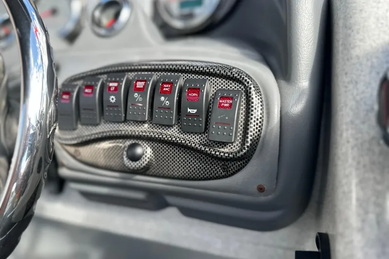 Slide: The Image of Dashboard controls of a 2011 South Bay 925 CR boat with carbon fiber accents. - 23