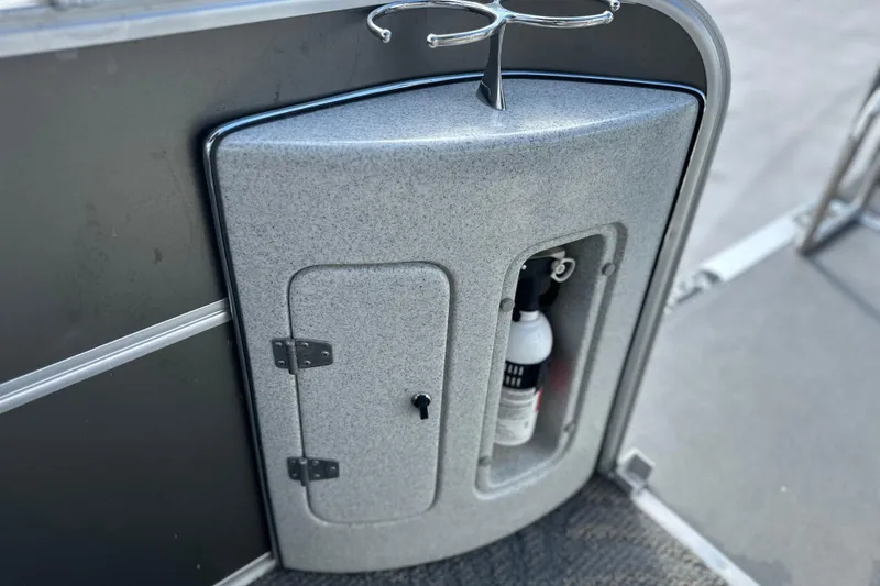 Slide: The Image of 2011 South Bay 925 CR boat compartment with fire extinguisher and cup holder. - 25
