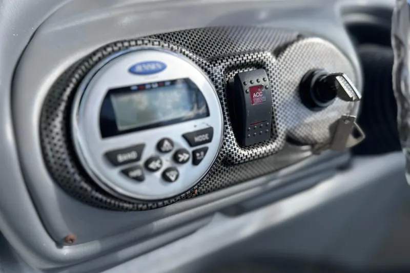 Slide: The Image of Dashboard controls of a 2011 South Bay 925 CR boat, featuring a stereo system and ignition key. - 28
