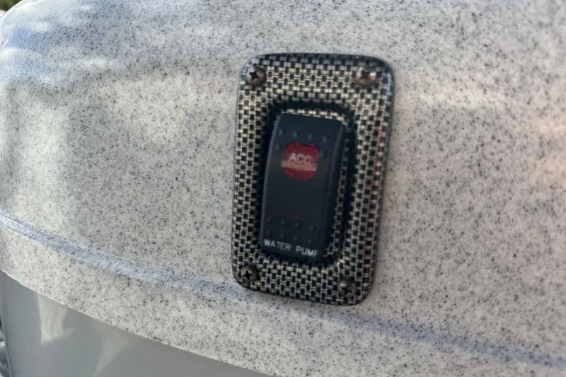 Slide: The Image of Water pump switch on 2011 South Bay 925 CR boat, textured surface background. - 31