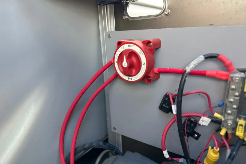 Slide: The Image of Electrical panel with red battery switch and wiring in a 2011 South Bay 925 CR. - 32