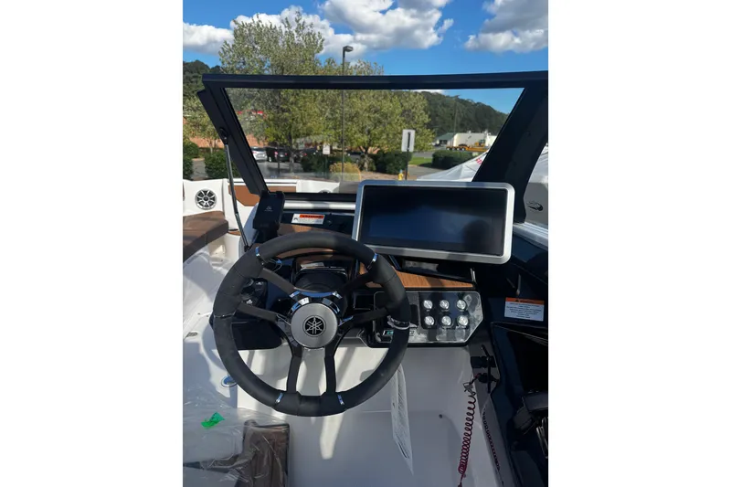 Slide: The Image of 2026 Yamaha Boat 222SE dashboard with steering wheel and touchscreen display. - 11