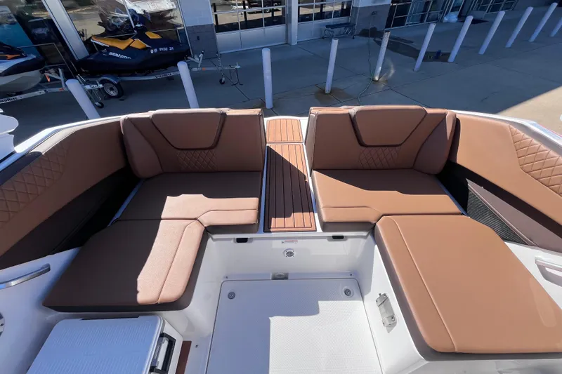 Slide: The Image of 2026 Yamaha Boat 222SE interior with brown cushioned seating and sleek design. - 5