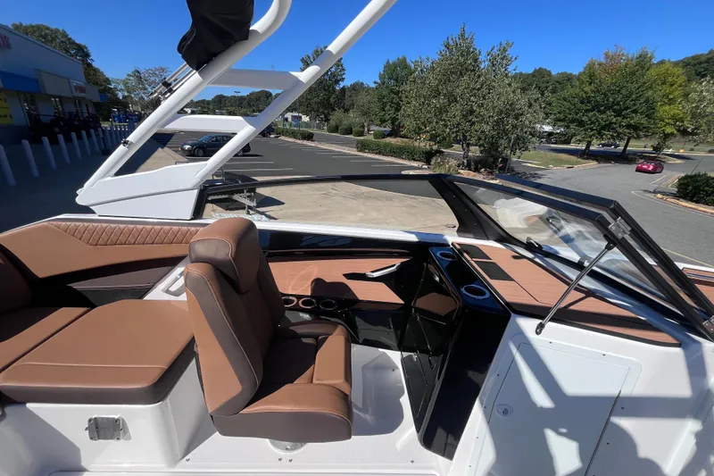Slide: The Image of 2026 Yamaha Boat 222SE interior with brown seating and sleek dashboard design. - 6