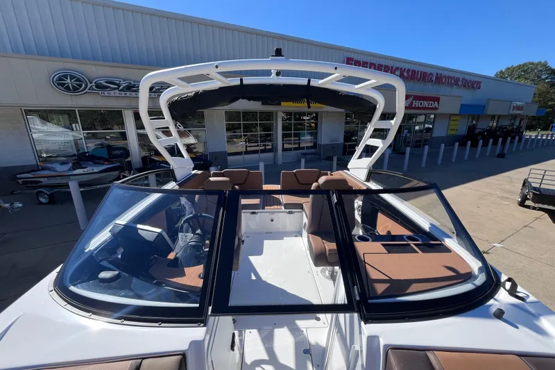 Slide: The Image of 2026 Yamaha Boat 222SE at dealership, showcasing sleek design and spacious seating. - 9