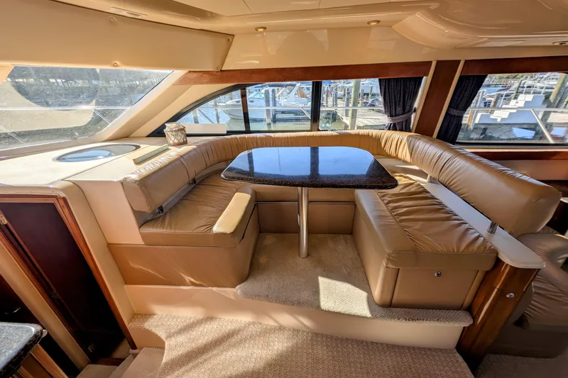 Slide: The Image of Luxurious interior of 2006 Meridian 411 Sedan yacht with leather seating and table. - 11