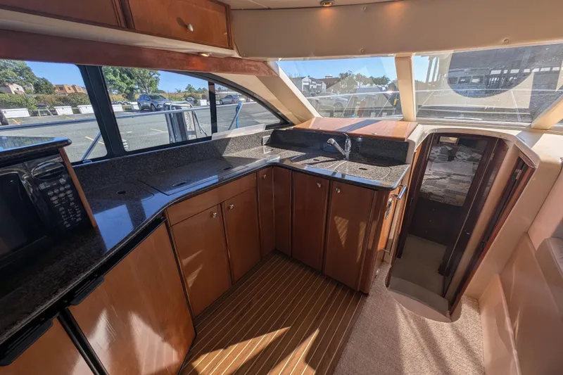 Slide: The Image of 2006 Meridian 411 Sedan yacht interior with modern kitchen and wood cabinetry. - 17