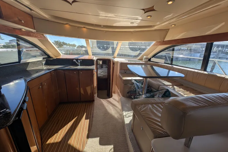 Slide: The Image of Luxurious interior of a 2006 Meridian 411 Sedan yacht with elegant seating and kitchen area. - 18