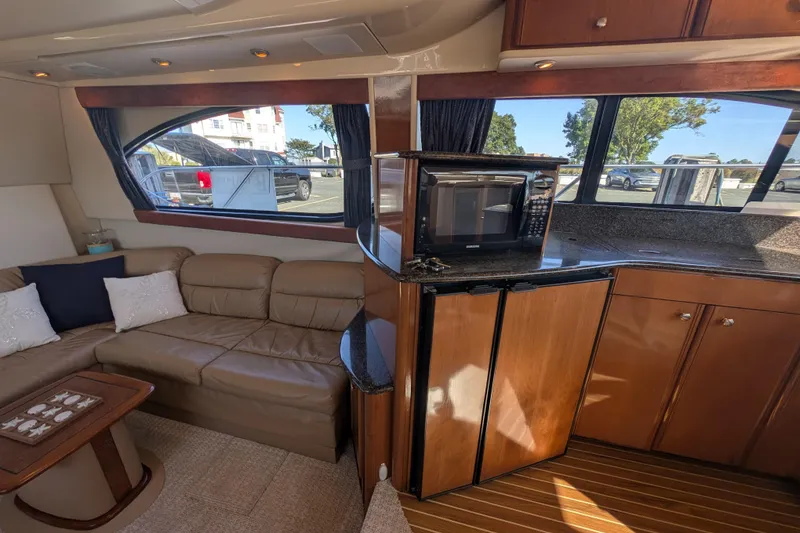 Slide: The Image of Luxurious interior of a 2006 Meridian 411 Sedan yacht with leather seating and kitchenette. - 20