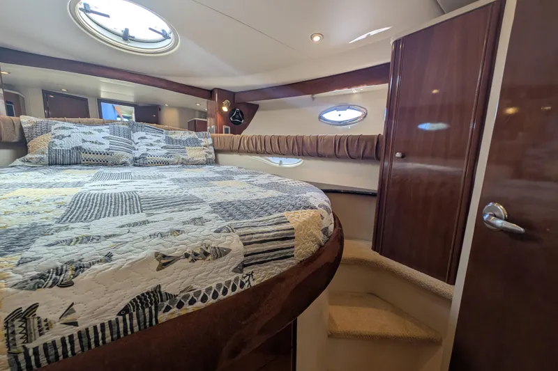 Slide: The Image of Luxurious cabin interior of a 2006 Meridian 411 Sedan yacht with a cozy bed. - 23