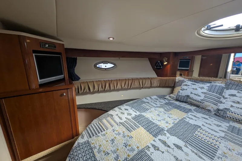 Slide: The Image of Luxurious interior of 2006 Meridian 411 Sedan yacht with cozy bedding and wood accents. - 24
