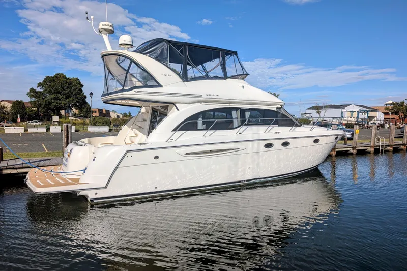 Slide: The Image of 2006 Meridian 411 Sedan yacht docked in a marina under a clear blue sky. - 3