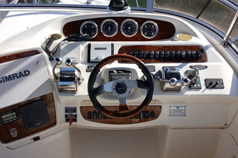 Slide: The Image of 2006 Meridian 411 Sedan helm with Simrad navigation and classic wood accents. - 34