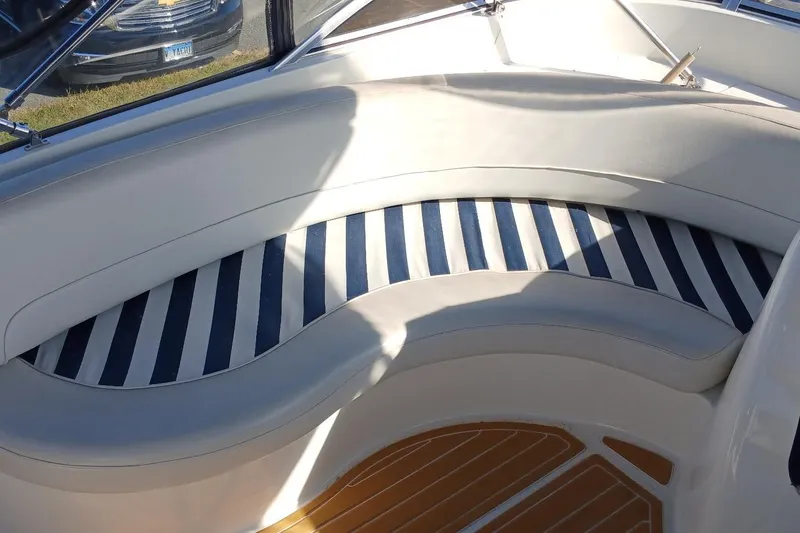 Slide: The Image of Curved seating area on 2006 Meridian 411 Sedan boat with striped cushions. - 35