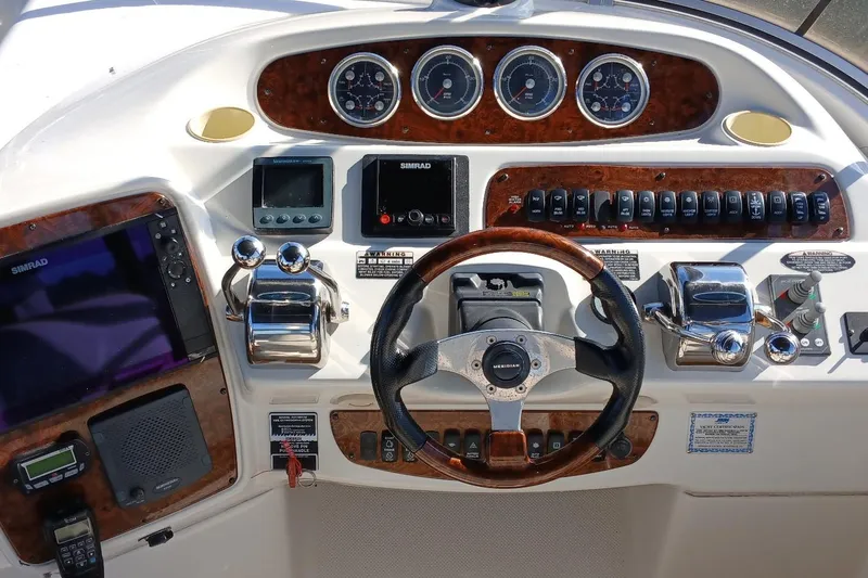 Slide: The Image of 2006 Meridian 411 Sedan helm with steering wheel, gauges, and navigation controls. - 36