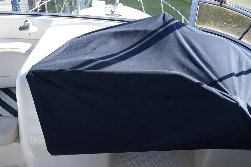 Slide: The Image of 2006 Meridian 411 Sedan boat interior with covered dashboard, docked at marina. - 40