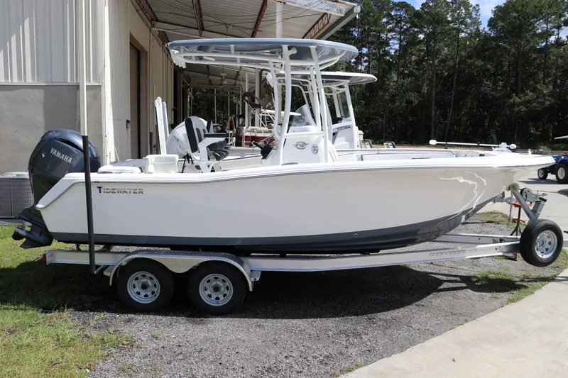 Slide: The Image of 2024 Tidewater 220 LXF boat on trailer, parked outdoors near a building. - 1