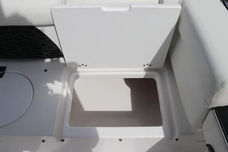 Slide: The Image of 2024 Tidewater 220 LXF boat storage compartment with open lid, showcasing interior space. - 12