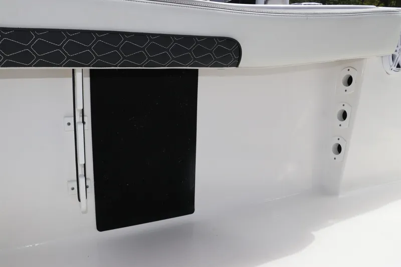 Slide: The Image of 2024 Tidewater 220 LXF boat interior detail with cushioned seating and storage compartment. - 15