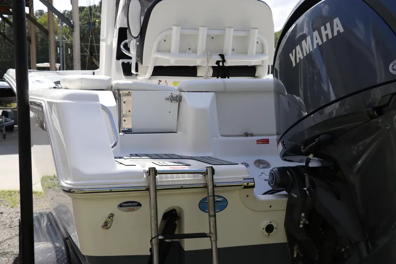 Slide: The Image of 2024 Tidewater 220 LXF boat with Yamaha engine, rear view showing seating and ladder. - 2