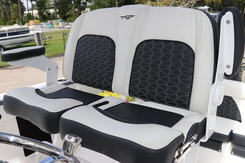 Slide: The Image of 2024 Tidewater 220 LXF boat seats with black and white upholstery, featuring hexagonal stitching. - 20