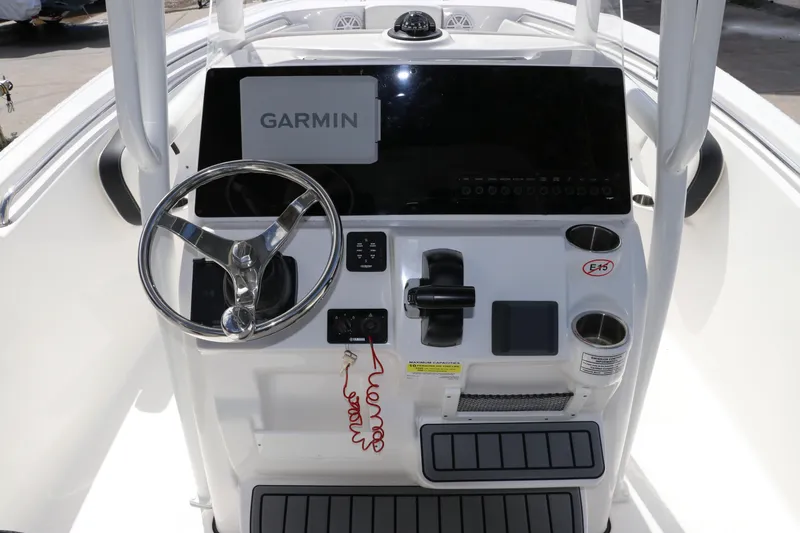 Slide: The Image of 2024 Tidewater 220 LXF boat console with Garmin display and steering wheel. - 23