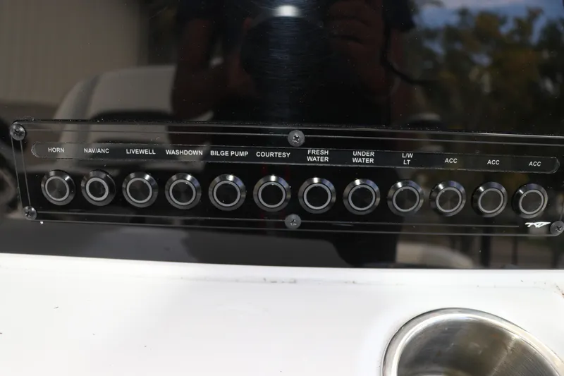Slide: The Image of Control panel of 2024 Tidewater 220 LXF boat with labeled switches and buttons. - 25