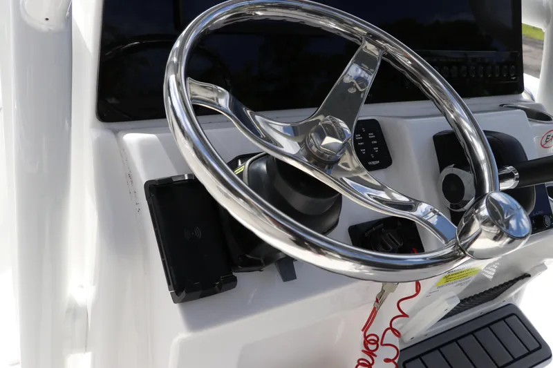 Slide: The Image of Steering wheel of 2024 Tidewater 220 LXF boat, featuring modern controls and design. - 27