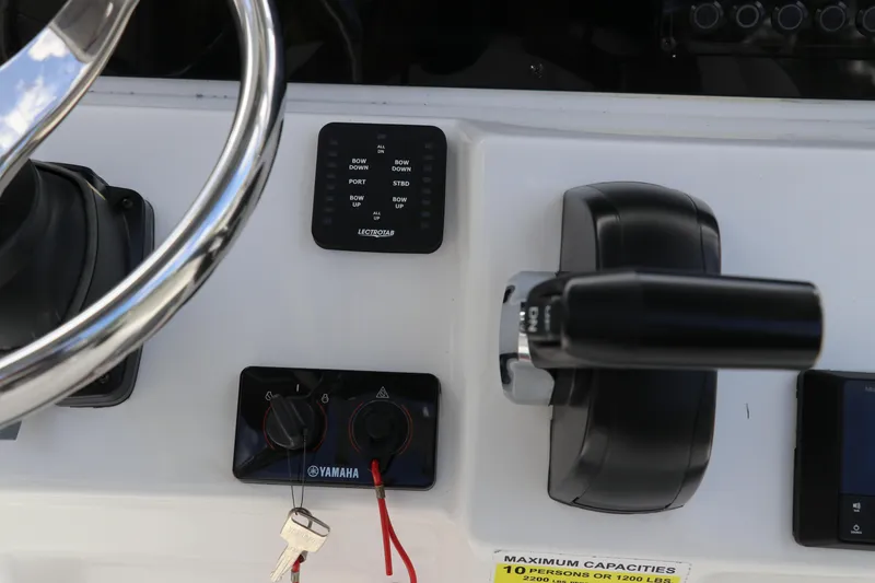 Slide: The Image of 2024 Tidewater 220 LXF boat controls with Yamaha throttle and steering wheel. - 28