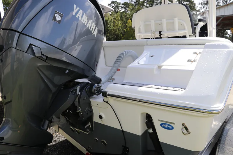 Slide: The Image of 2024 Tidewater 220 LXF boat with Yamaha engine, rear view, outdoors. - 3