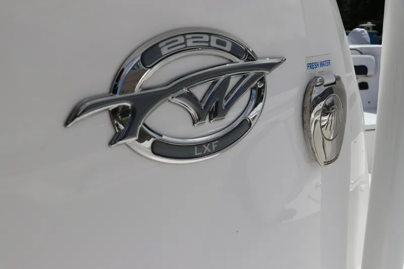 Slide: The Image of 2024 Tidewater 220 LXF boat emblem and fresh water access. - 31