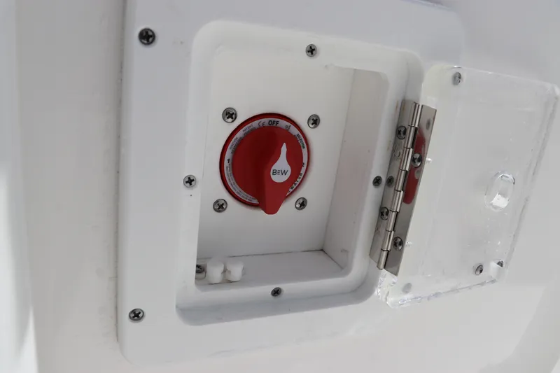 Slide: The Image of 2024 Tidewater 220 LXF boat battery switch with protective cover. - 32