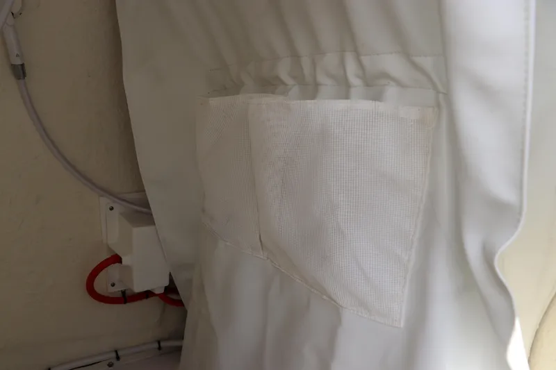 Slide: The Image of Interior detail of 2024 Tidewater 220 LXF boat, featuring a storage pocket and wiring. - 34