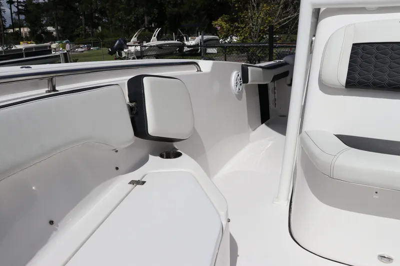 Slide: The Image of 2024 Tidewater 220 LXF boat interior with white seating and cup holder. - 38