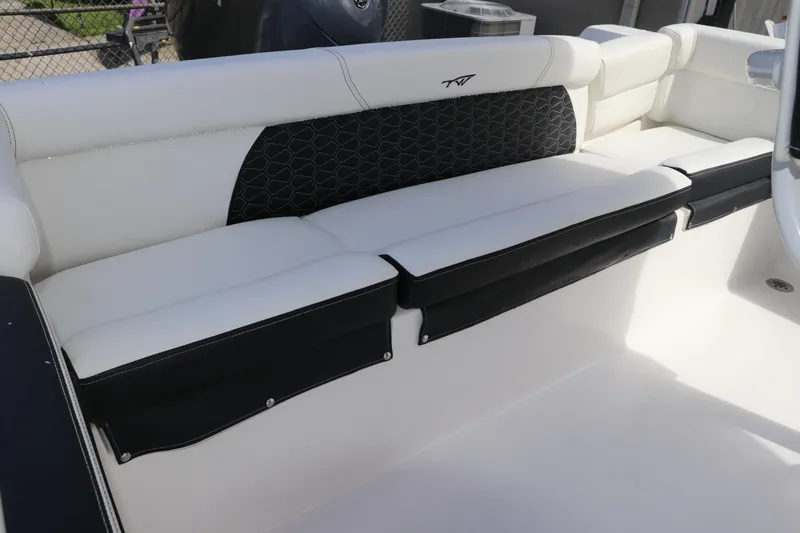 Slide: The Image of 2024 Tidewater 220 LXF boat interior with sleek white seating and black accents. - 4