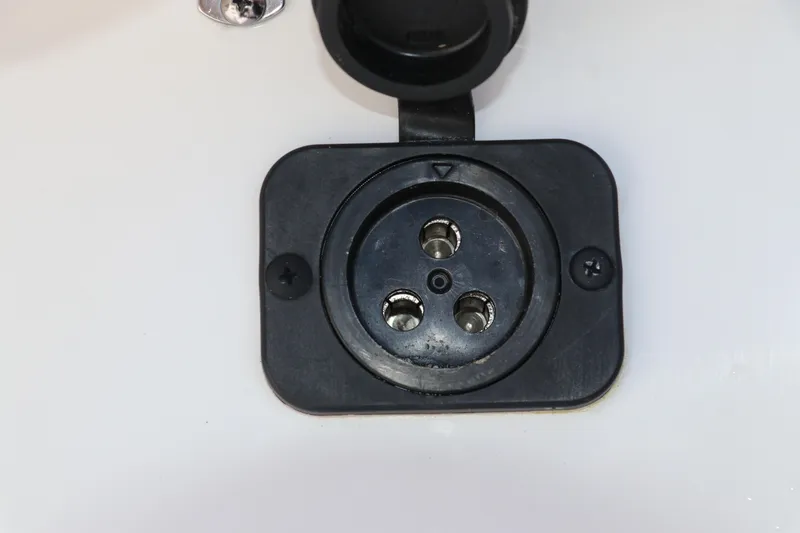 Slide: The Image of Close-up of a 2024 Tidewater 220 LXF boat's electrical socket. - 40