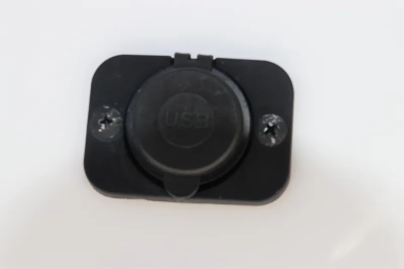 Slide: The Image of USB port on 2024 Tidewater 220 LXF boat, black cover, mounted on white surface. - 42