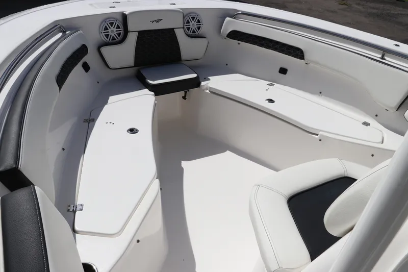Slide: The Image of 2024 Tidewater 220 LXF boat interior with white seating and storage compartments. - 43