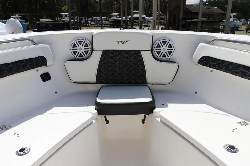 Slide: The Image of 2024 Tidewater 220 LXF boat interior with cushioned seating and speakers. - 44
