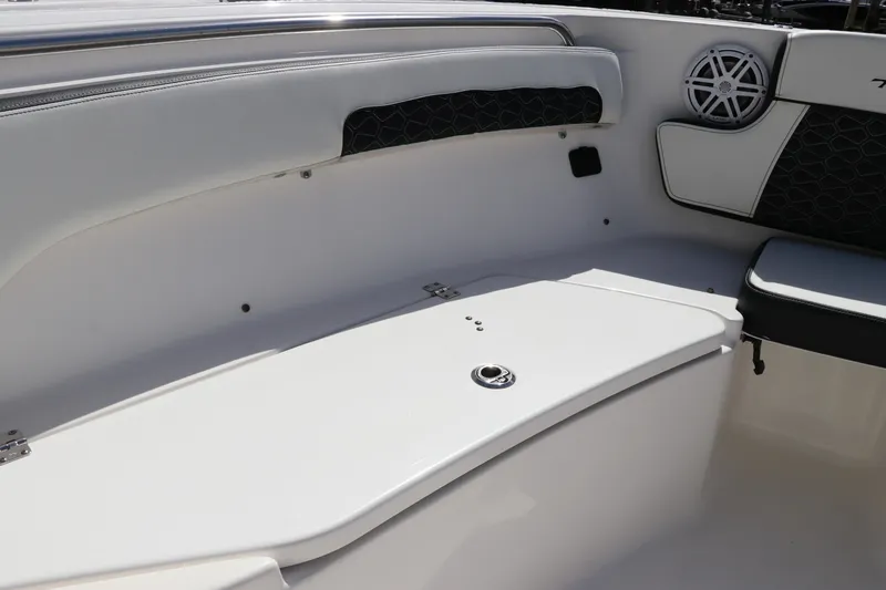 Slide: The Image of 2024 Tidewater 220 LXF boat interior with white seating and speaker detail. - 45
