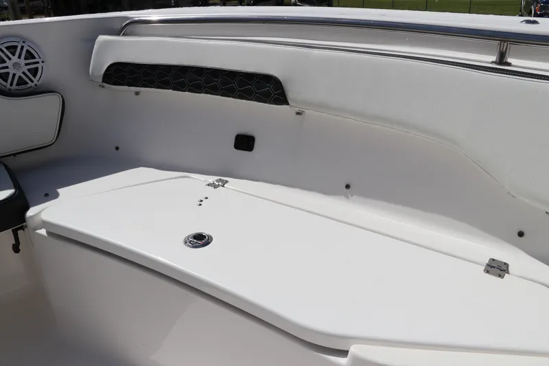 Slide: The Image of 2024 Tidewater 220 LXF boat interior with white seating and storage compartment. - 46