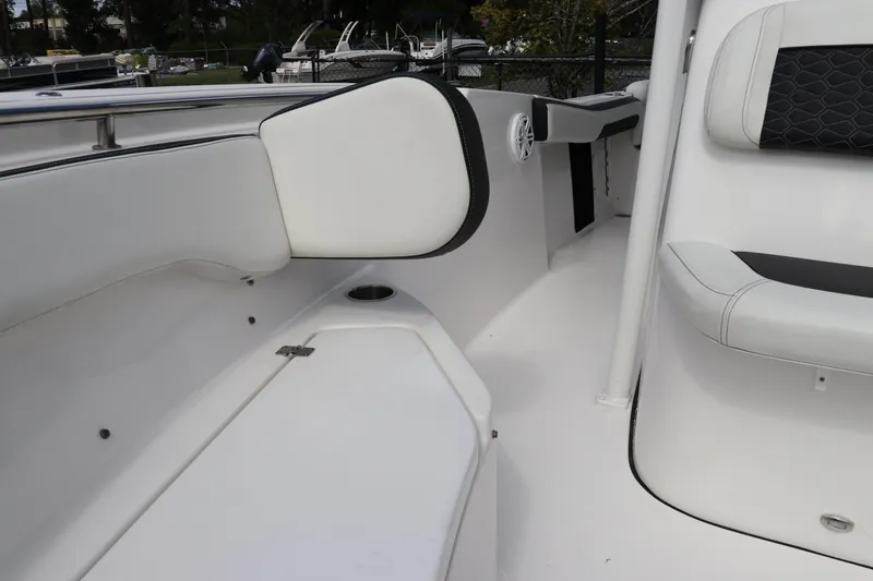 Slide: The Image of 2024 Tidewater 220 LXF boat interior with white seating and sleek design. - 49