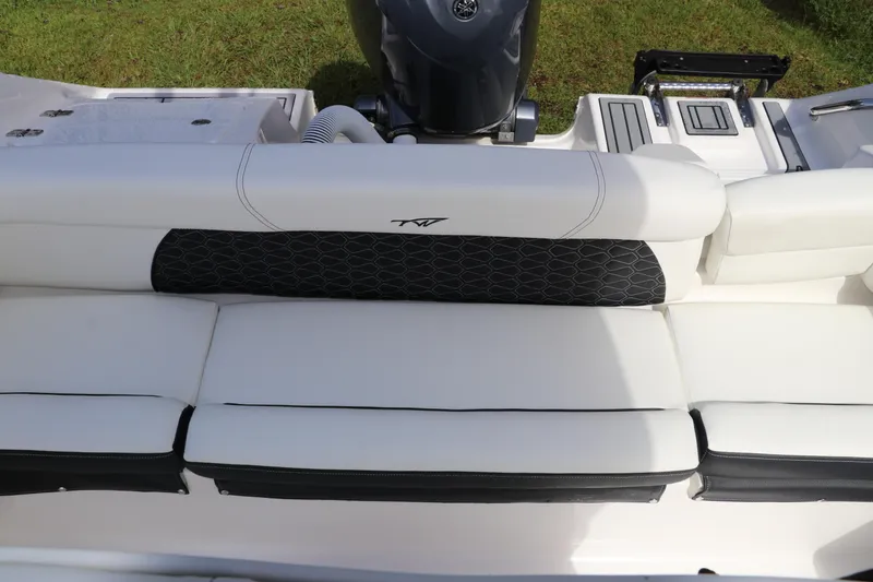 Slide: The Image of 2024 Tidewater 220 LXF boat interior with white cushioned seating and black accents. - 5